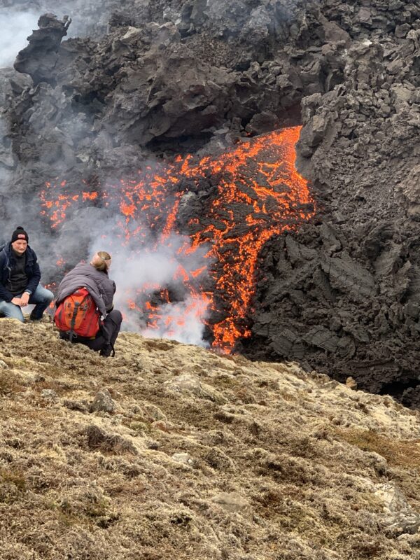 Tourist watching the lava flow in Iceland