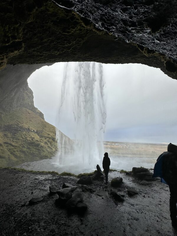 South Coast Iceland. Walking behind Seljalandsfoss waterfall